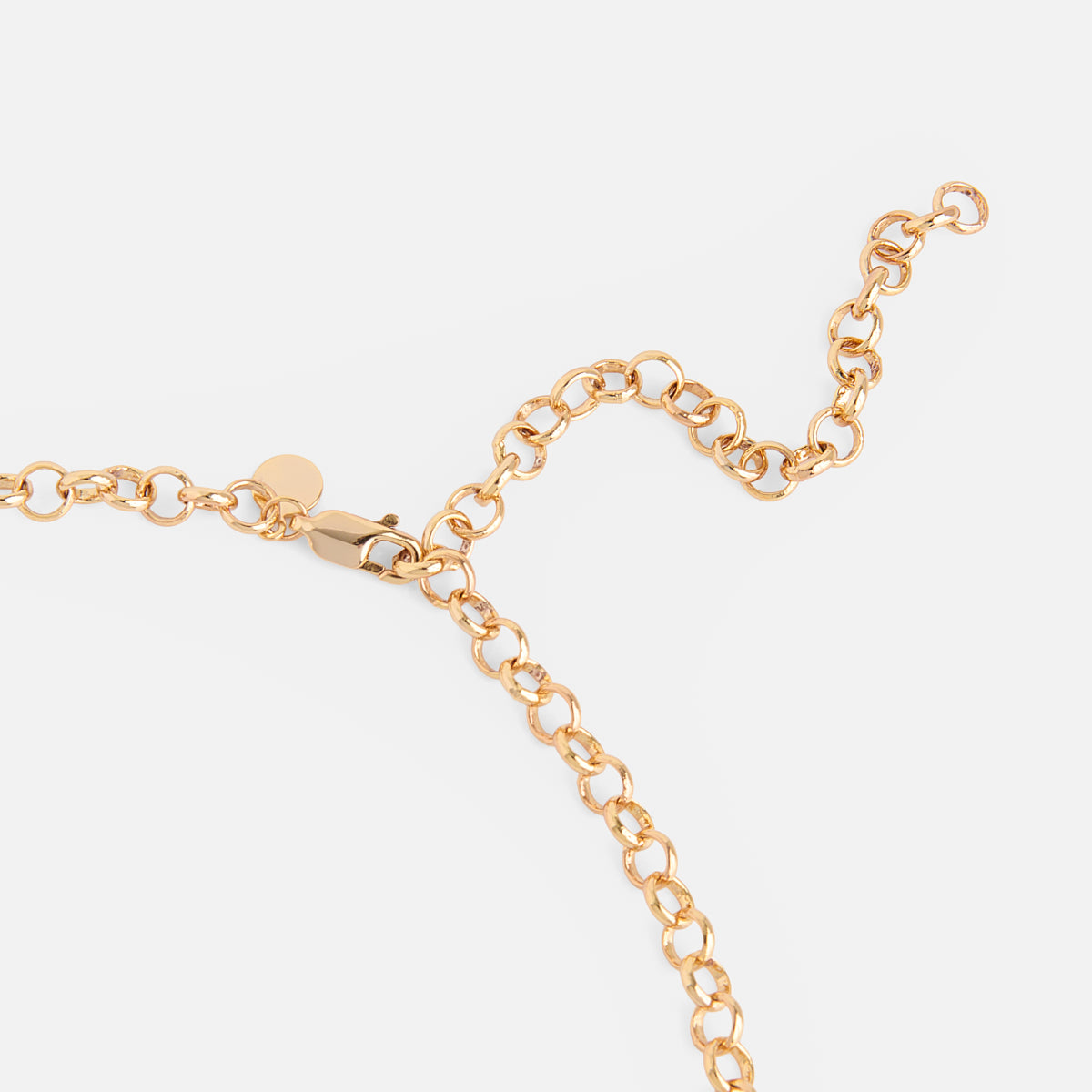 Close-up of the Cameron Charm Holder Necklace, a gold chain with round links and a lobster clasp, displayed on a white background.