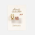 The Bold Birthstone Earring Set features gold plated hoops, small gold hoops with pink stones, and tiny pink gemstone studs on a white textured jewelry card.
