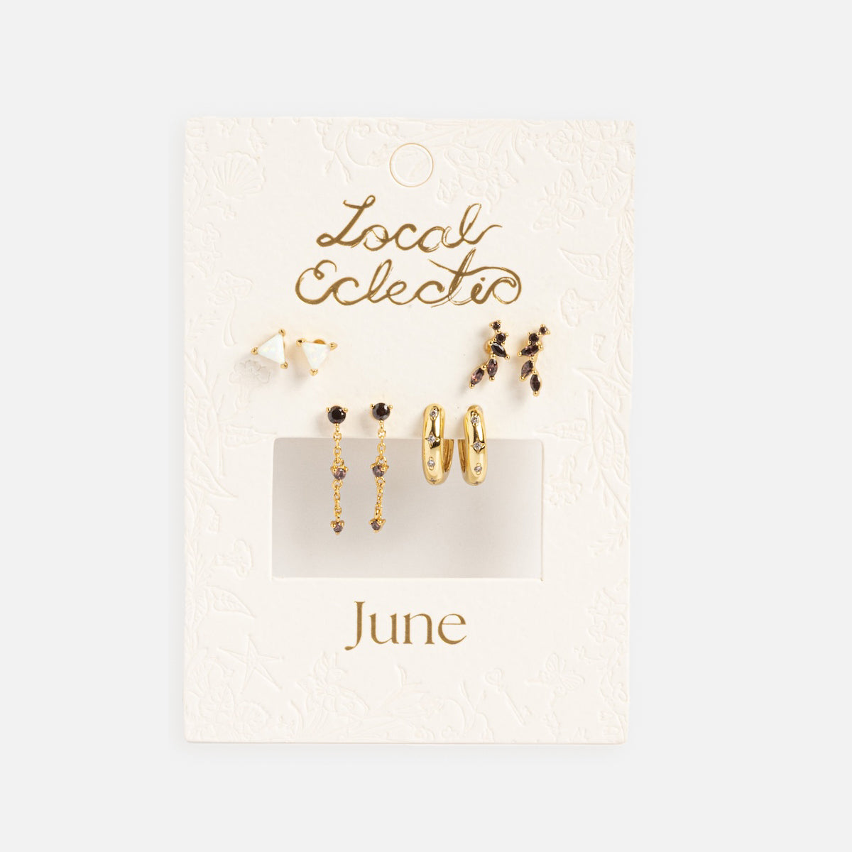 The Classic Birthstone Earring Set features four pairs of 14k gold plated and gemstone earrings—studs, hoops, and dangles—displayed on a textured white card labeled Local Eclectic and June for a personalized ear stack.