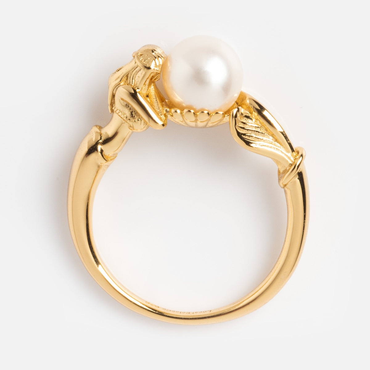 The Pearl Siren Statement Ring features a white pearl held by two sculpted hands with leaf details on the band, offering vintage-inspired elegance and unique charm, shown against a white background.