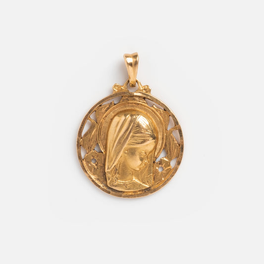 Vintage 18k gold Mother Mary coin charm with openwork details, featuring a raised profile of Mary in a headscarf and an ornate circular frame inspired by Art Nouveau designs.