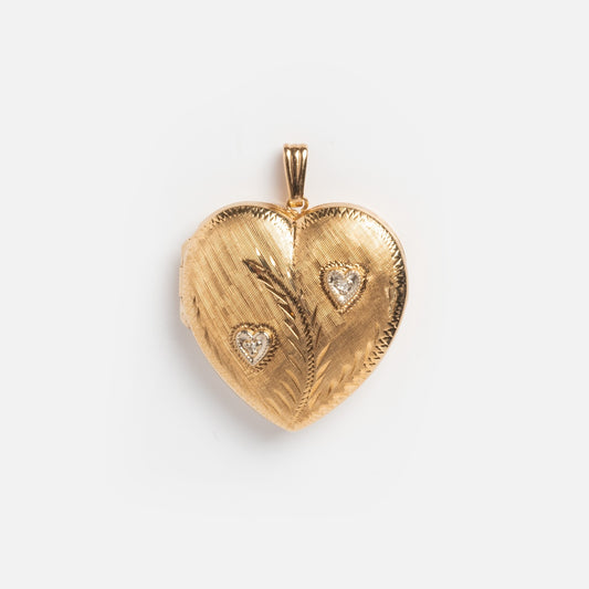 This Vintage 14k Etched Heart Locket With Diamonds is a textured, heart-shaped gold pendant featuring diamond accents and a leaf-inspired design, shown on a plain white background.