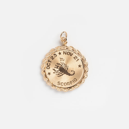 The Vintage 14k Scorpio Textured Coin Charm features a scorpion illustration, Scorpio zodiac symbol, and Oct 23 - Nov 21 engraved along the edge—an iconic vintage jewelry piece.
