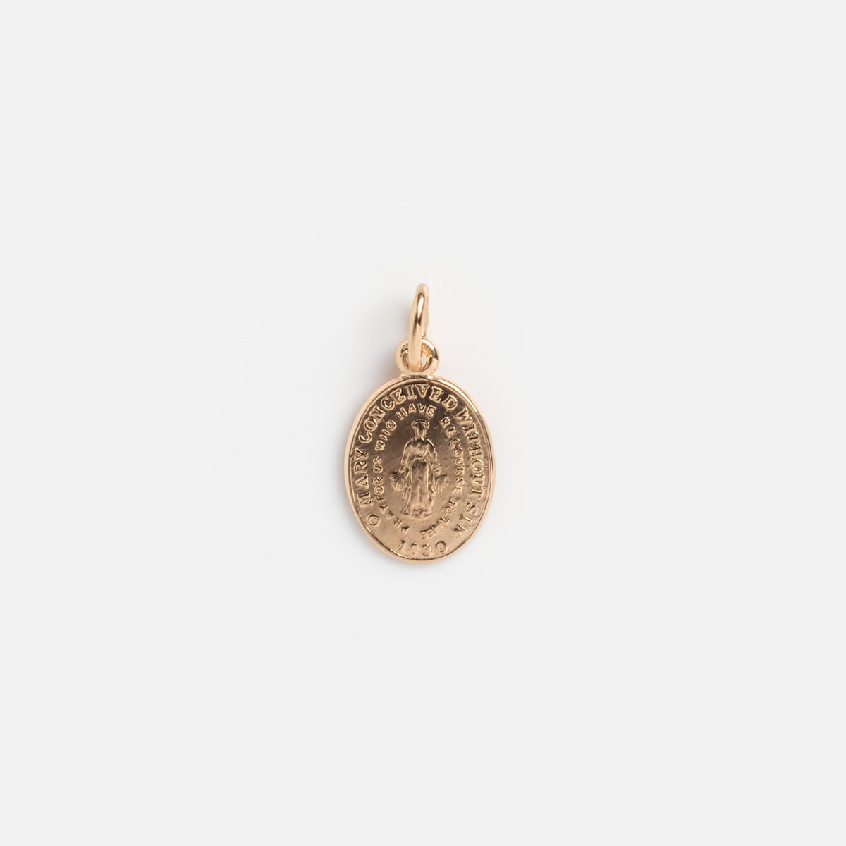 The Vintage 14k Miraculous Medal Charm is a small oval gold pendant engraved with a religious figure and surrounded by text, featuring a loop for wearing on a chain, shown on a plain white background.