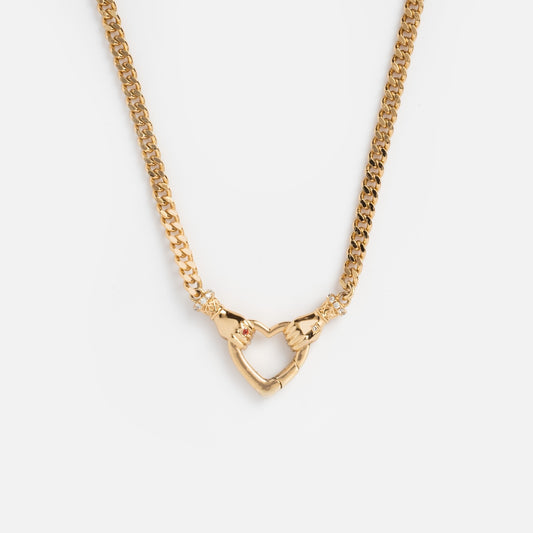 The Hand Over Heart Charm Holder Necklace in 14k gold vermeil features two hands forming a heart at the center with delicate accents, shown on a plain white background.