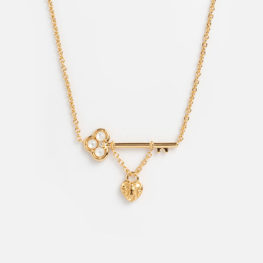 The Lock and Key Necklace features a gold vermeil chain with a skeleton key pendant and a small heart charm—an ideal accessory for lovers of vintage romance.