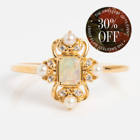 The Crown Jewel Opal and Pearl Ring features a rectangular opal center, pearl accents, and diamond details in 14k yellow gold vermeil. A circular sticker reads: THE SWEETEST GIFTS EVENT 30% OFF.