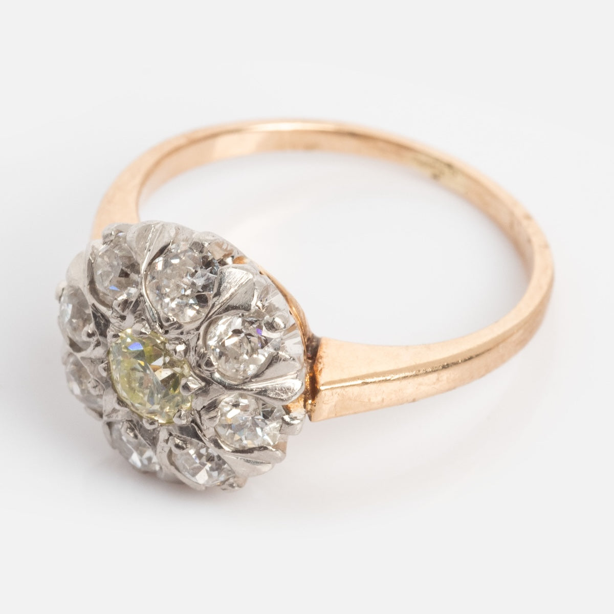 Vintage 14k 1920s Euro Cut Diamond Cluster Ring, size 5, features a round floral cluster design with central yellow gemstone and diamonds, set in elegant yellow gold. Photographed on a plain white background.