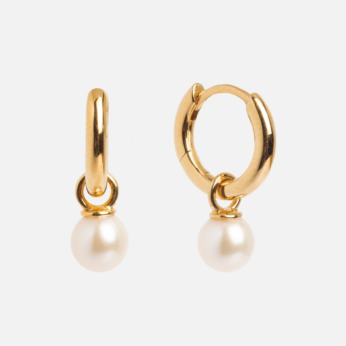 Pearl Keepsake Huggie Hoops: gold vermeil earrings with a freshwater pearl elegantly dangling from each small hoop, displayed on a plain white background.