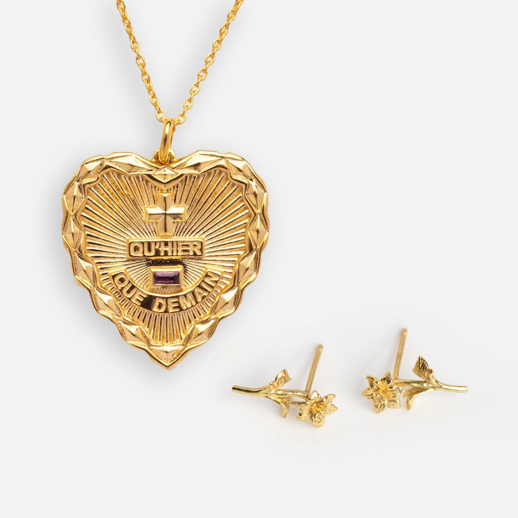 The Valentines Day Hearts and Flowers Gift Set features a gold heart pendant necklace with French text and textured design, paired with delicate gold birth flower earrings shaped like floral branches, displayed on a white background.