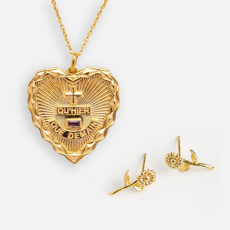 The Valentines Day Hearts and Flowers Gift Set features a gold heart pendant necklace with QUHIER QUE DEMAIN engraving and birth flower earrings—an adorable jewelry set beautifully displayed on a white background.