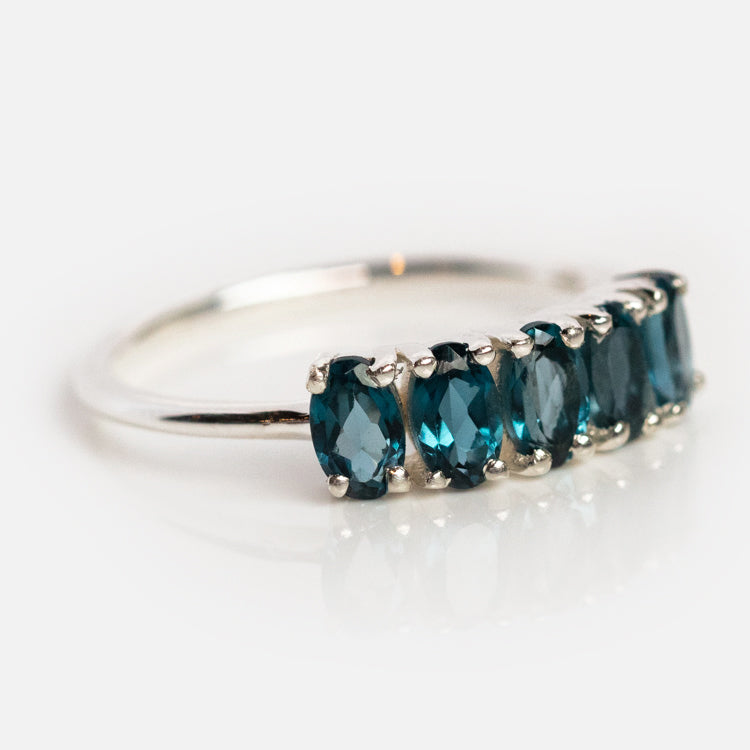 The London Blue Topaz Galaxy Ring in Silver features six oval London blue topaz gemstones set side by side on a sterling silver band, shown against a white background.