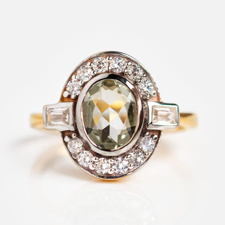 A close-up of the Oval Deco Green Amethyst and CZ Ring gleams in gold vermeil, reflecting the elegance of Art Deco style.
