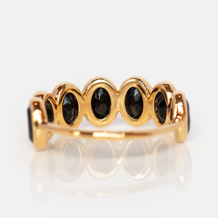The Violeta Black Onyx Ring showcases five oval black onyx stones set in a row on 14k yellow gold vermeil, displayed side view against a white background.