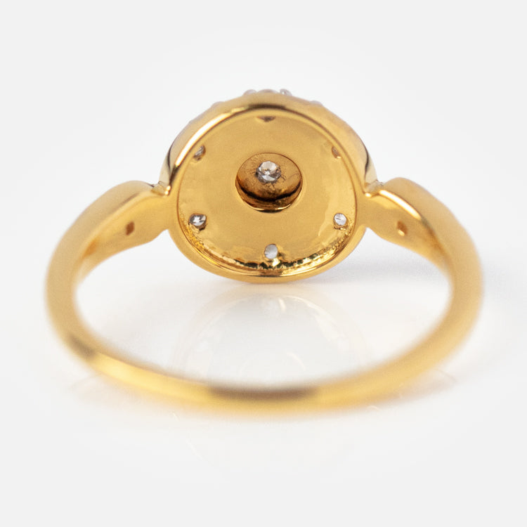 The Vintage Star Compass Ring, crafted in 14k yellow gold plating, features a round setting with a central small diamond, four accent diamonds, and a smooth shiny band, all showcased against a white background.