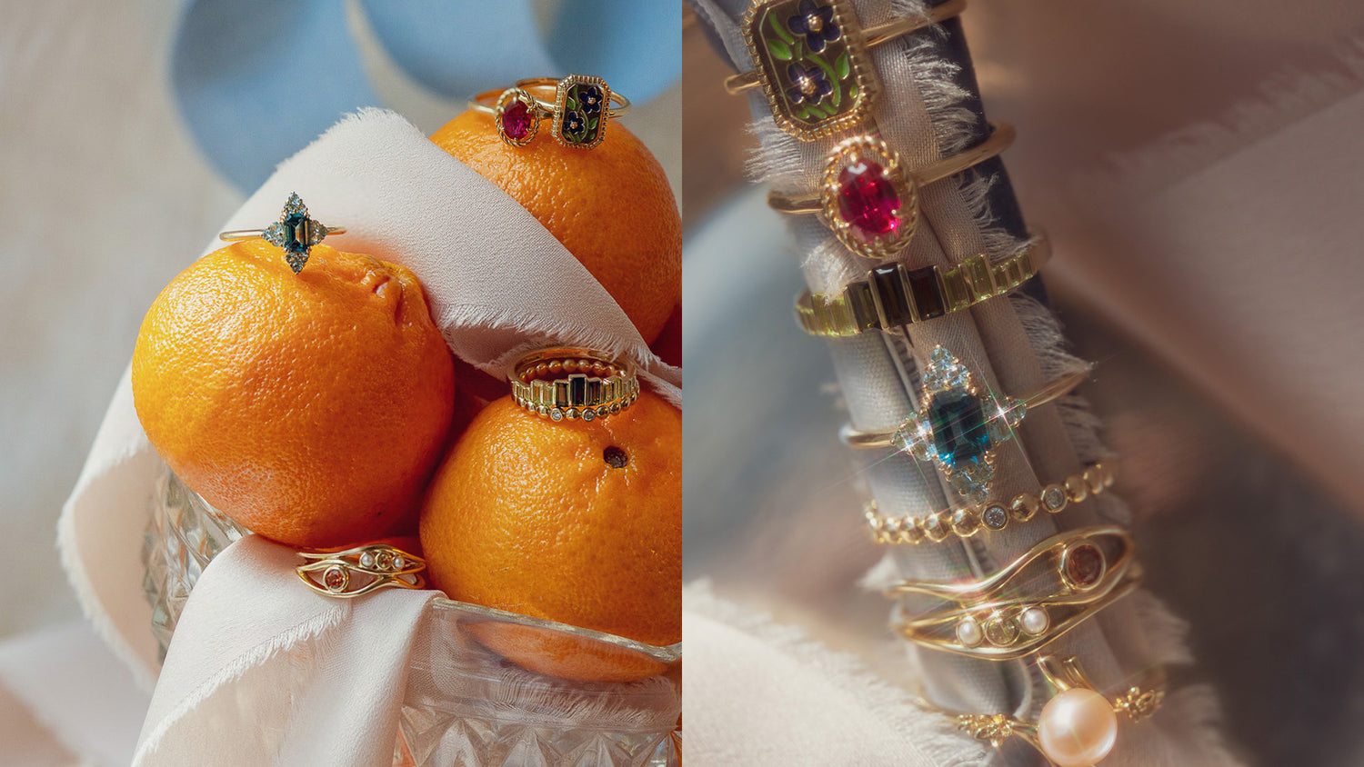 Gold gemstone rings displayed on oranges and gold rings on a wrapped piece of light blue fabric