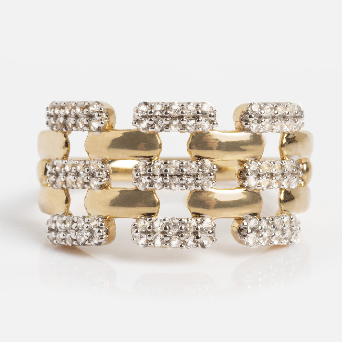 The Solid Gold Mirrored Light Diamond Statement Ring features a wide openwork band with three rows of rectangular sections, each accented by sparkling white stones.