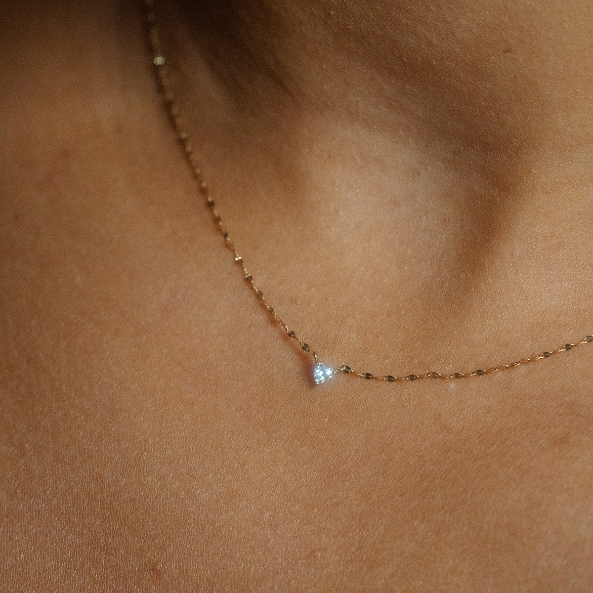 A close-up of the Limited Edition Valentine's Day Solid Gold Hearts Gift Set necklace, featuring a small heart pendant in solid gold, beautifully displayed against bare skin—an ideal romantic jewelry piece for Valentine’s Day.