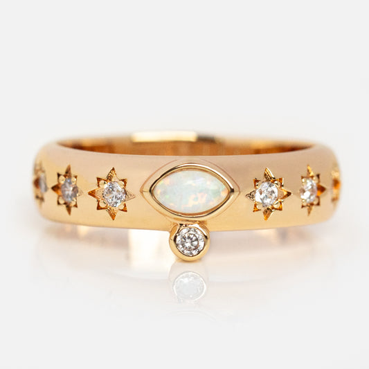 The Athena Opal Ring Sample Size 8 is a 14k yellow gold plated ring with a marquise synthetic opal center, starburst-set round diamonds, and a dangling diamond on the 4mm band. Shown against a plain white background.