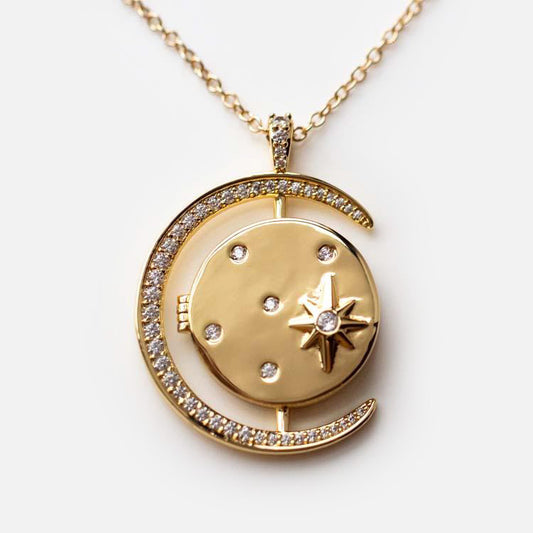 The Luna Locket Necklace features a gold-plated crescent moon with sparkling diamonds, encircling a round pendant accented with diamonds and a star—an elegant celestial piece for lovers of starburst necklace designs.