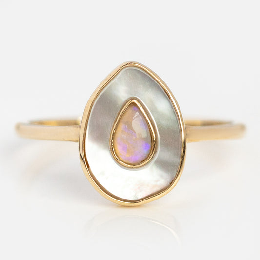 The Solid Gold Opal and Mother of Pearl Organic Teardrop Ring (Sample Size 7) features a teardrop-shaped Australian opal set within a larger mother-of-pearl inlay, both bordered by 9k yellow gold on a simple band.