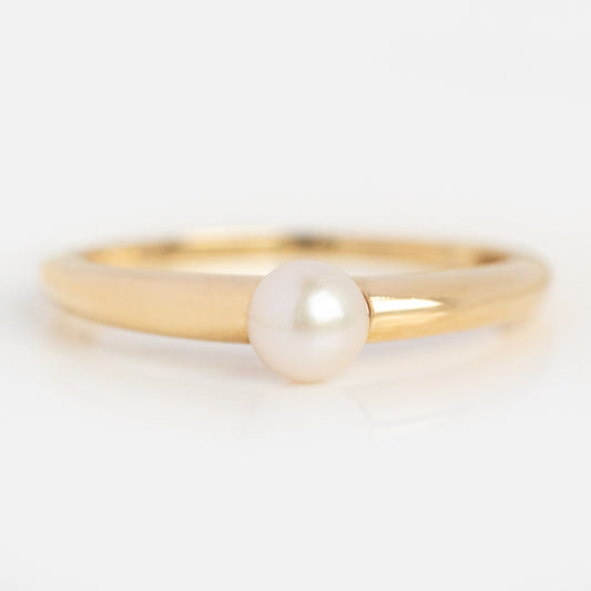 The Solid Gold Bold Pearl Ring Sample features a single round Freshwater pearl set at the center of a simple 9k yellow gold band, shown on a white background.