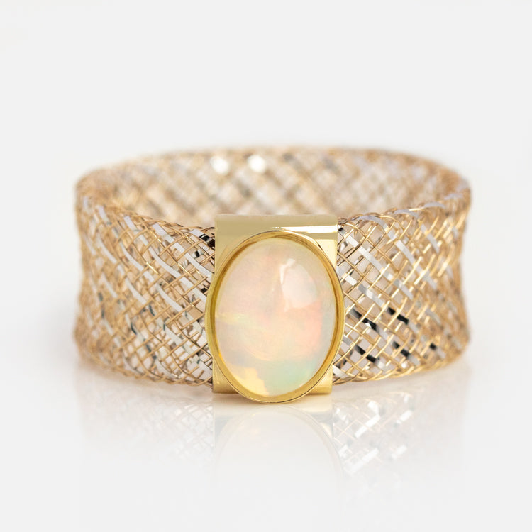 A solid gold mesh gemstone ring, sample size 11, with a wide band and elegant oval opal centerpiece set in polished gold, displayed on a white background. The 9mm bold design channels the sophistication of classic opal jewelry.