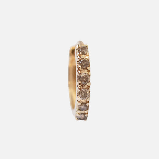 The Solid Gold Salt and Pepper Diamond Huggie Hoop Single, set with a row of round salt and pepper diamonds, is displayed upright against a plain white background.