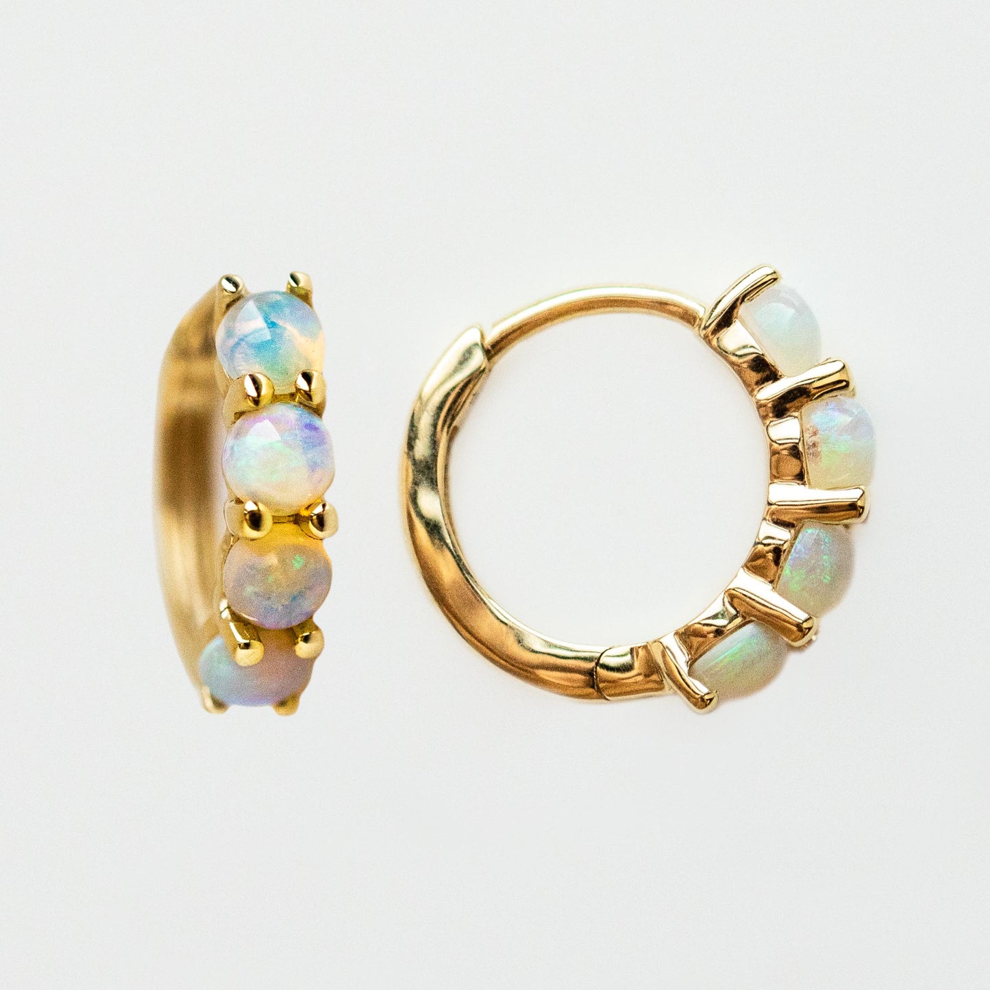 Solid Gold Australian Opal Huggie Hoops Sample: 10k yellow gold hoops, each featuring five 3mm round natural opals, shown on a plain white background.