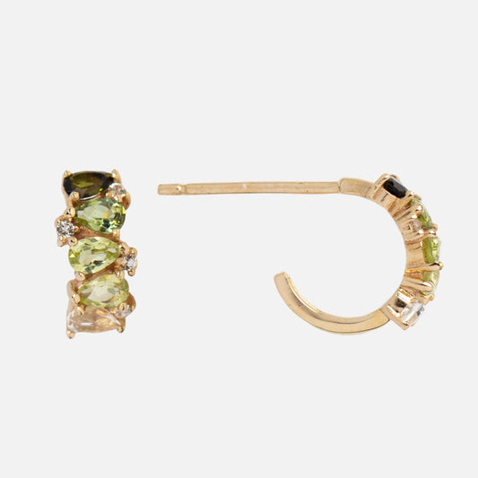 The Solid Gold Ombre Birthstone Huggie Hoops feature green, yellow, and clear gemstones set along the front. Shown from both side and front to highlight their unique ombre birthstone design in 9k gold.