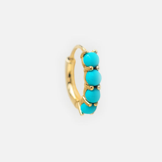 Solid Gold Turquoise Huggie Hoops: These gold hoop earrings feature four round Arizona turquoise beads along the front, shown on a plain white background—ideal for anyone who loves turquoise huggies.