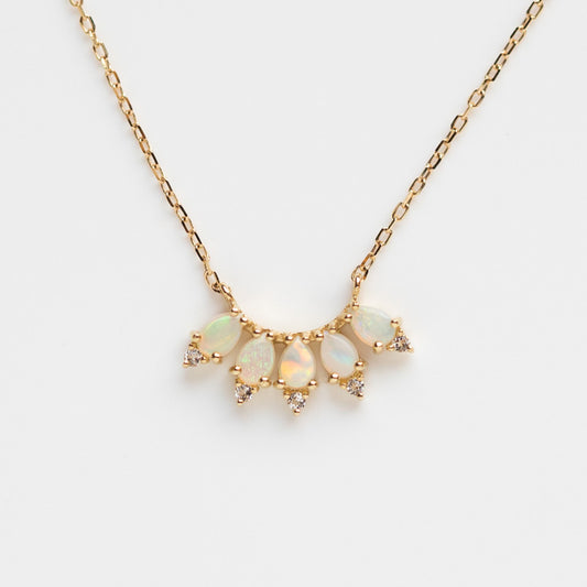 The Solid Gold Ombre Birthstone Necklace Opal Sample showcases five opal teardrop stones, each accented by diamond clusters, set in 9k yellow gold and elegantly displayed against a white background.