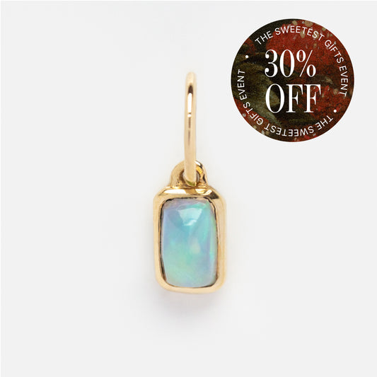 Discover the Solid Gold Birthstone Baguette Charm pendant, a rectangular opal gemstone set in gold with a gold loop. In the top right corner, a round "30% OFF" sticker reads "THE SWEETEST GIFTS EVENT.