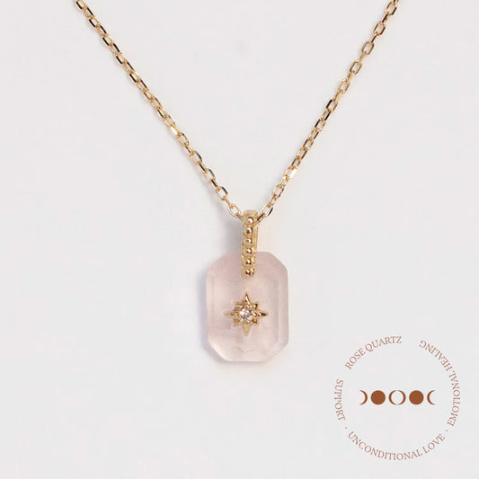 The Solid Gold Crystal Pendant Necklace for Manifestation Rose Quartz Sample features a yellow gold chain and faceted rectangular rose quartz pendant with a central star-shaped gold detail. Gold text and moon phases decorate the bottom right corner.