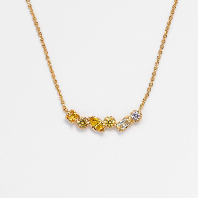 The Shades of You Ombre Birthstone Necklace features five distinct gemstone shapes—round, oval, rectangular, and marquise—lined up on gold for a personalized birthstone piece.