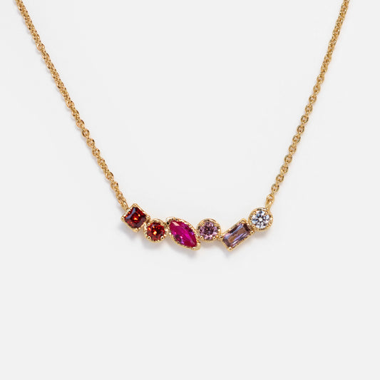 The Shades of You Ombre Birthstone Necklace features five unique gemstones in red, pink, purple, and clear hues set in a row, creating an elegant ombre look.