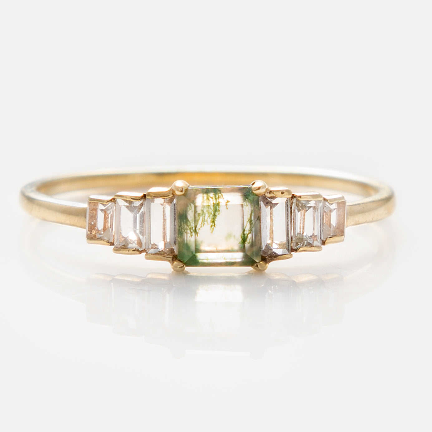 The Solid Gold Aquatic Agate Ring for Grounding (size 7) features a rectangular moss agate center and three baguette-cut white sapphires on each side, crafted in 9k solid yellow gold, shown on a white background.