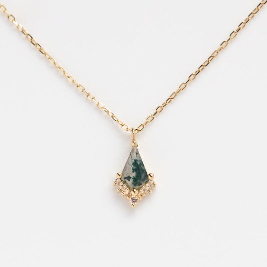 The Solid Gold Aquatic Agate Elements Kite Necklace Sample is a 9k yellow gold chain with a geometric pendant featuring green marbled agate and white topaz crystals along the bottom edge, shown on a white background.