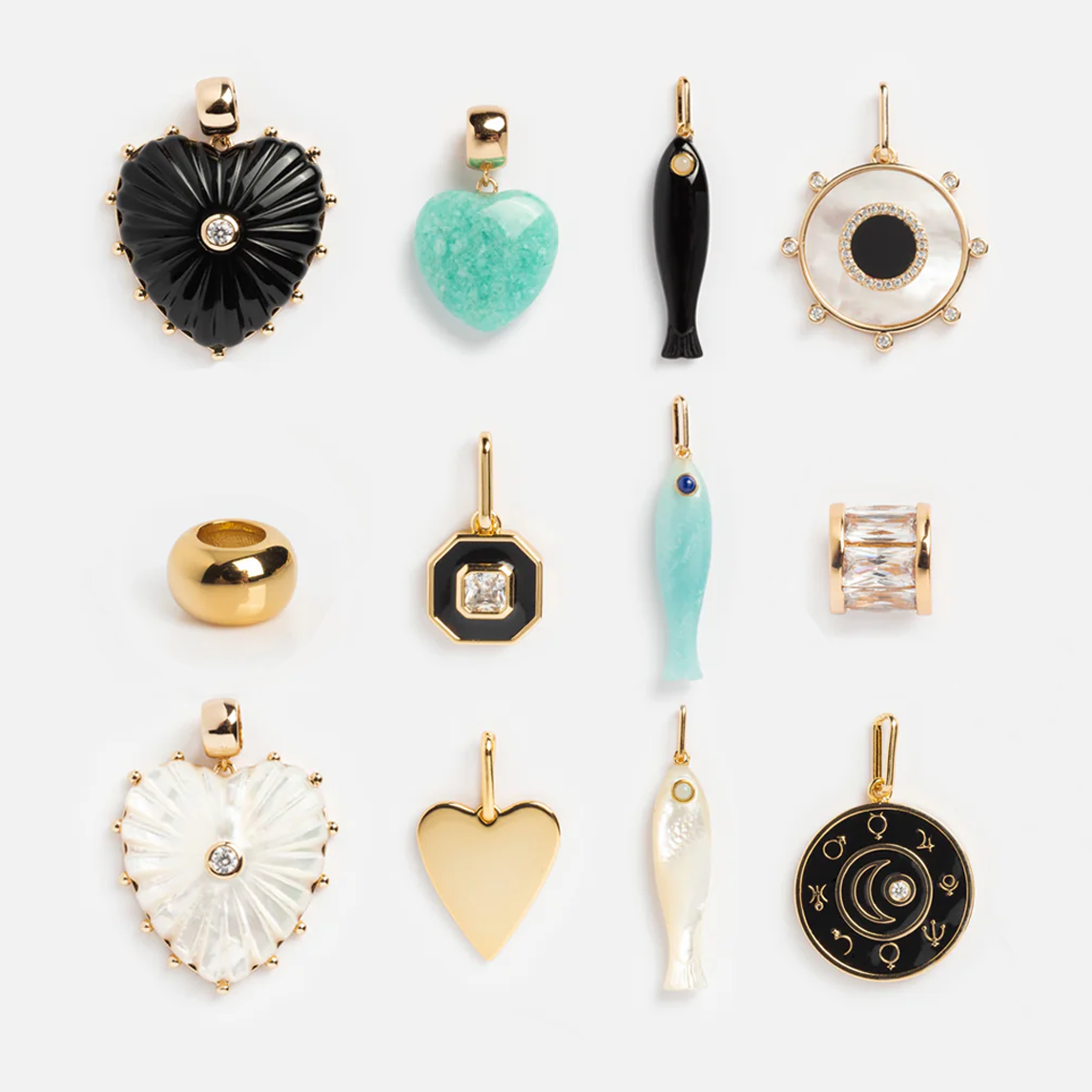 Charms by Thatch: a set of twelve gold-plated pendants featuring heart, fish, circle, and celestial designs accented with black, green, white, blue, and clear jewels. Ideal for creating personalized necklace charms.