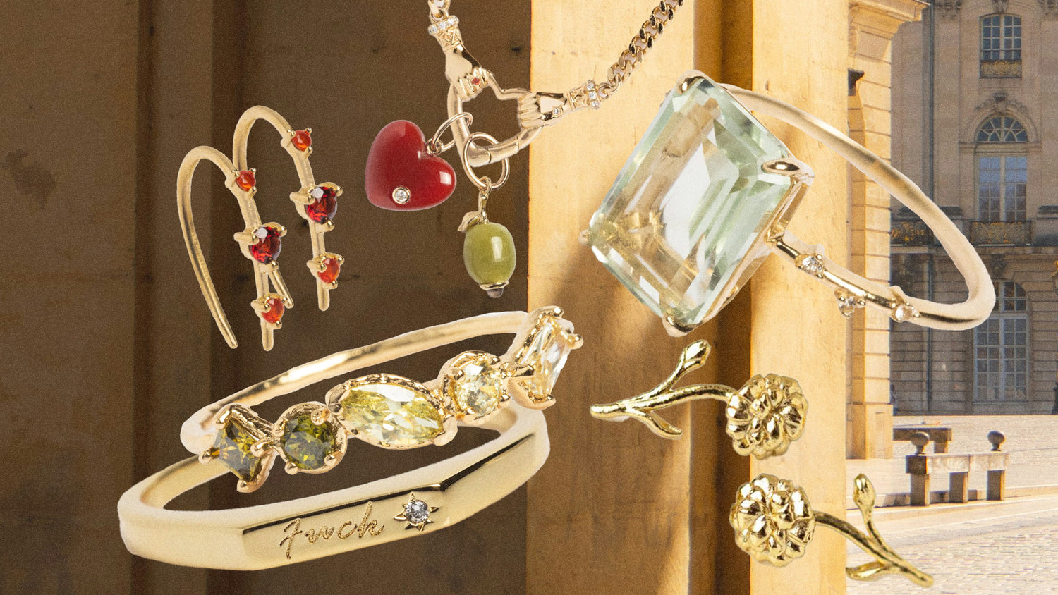 Gold jewelry with gemstones on a blurred background. Trending Jewelry with gemstones, rings, earrings, necklaces, an olive charm, a heart charm, flower earrings, tiny fuck ring, birthstone jewelry. 2026 Jewelry Trends