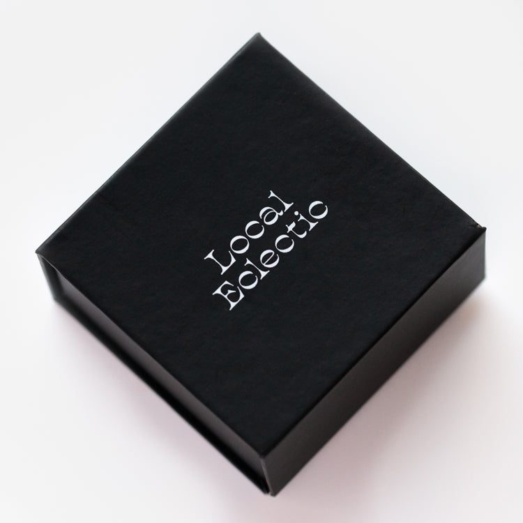 A black square box with Local Eclectic in white on the lid, shown on a white background—perfect for gifting the Valentines Day Hearts and Flowers Gift Set.