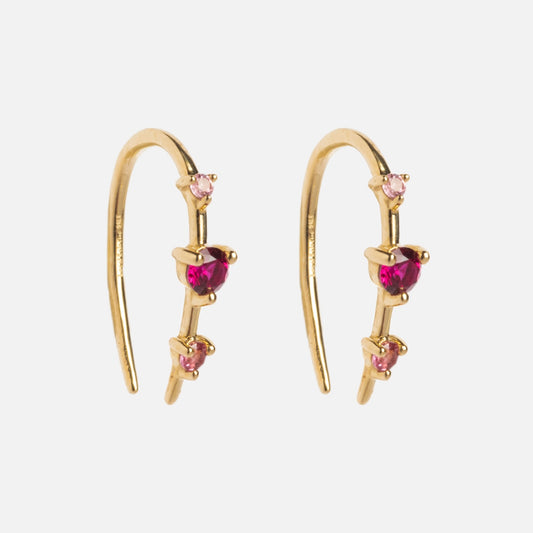 Solid Gold Ombre Birthstone Ear Huggers feature three pink and red gemstones in a vertical line on each curved earring, shown against a white background.