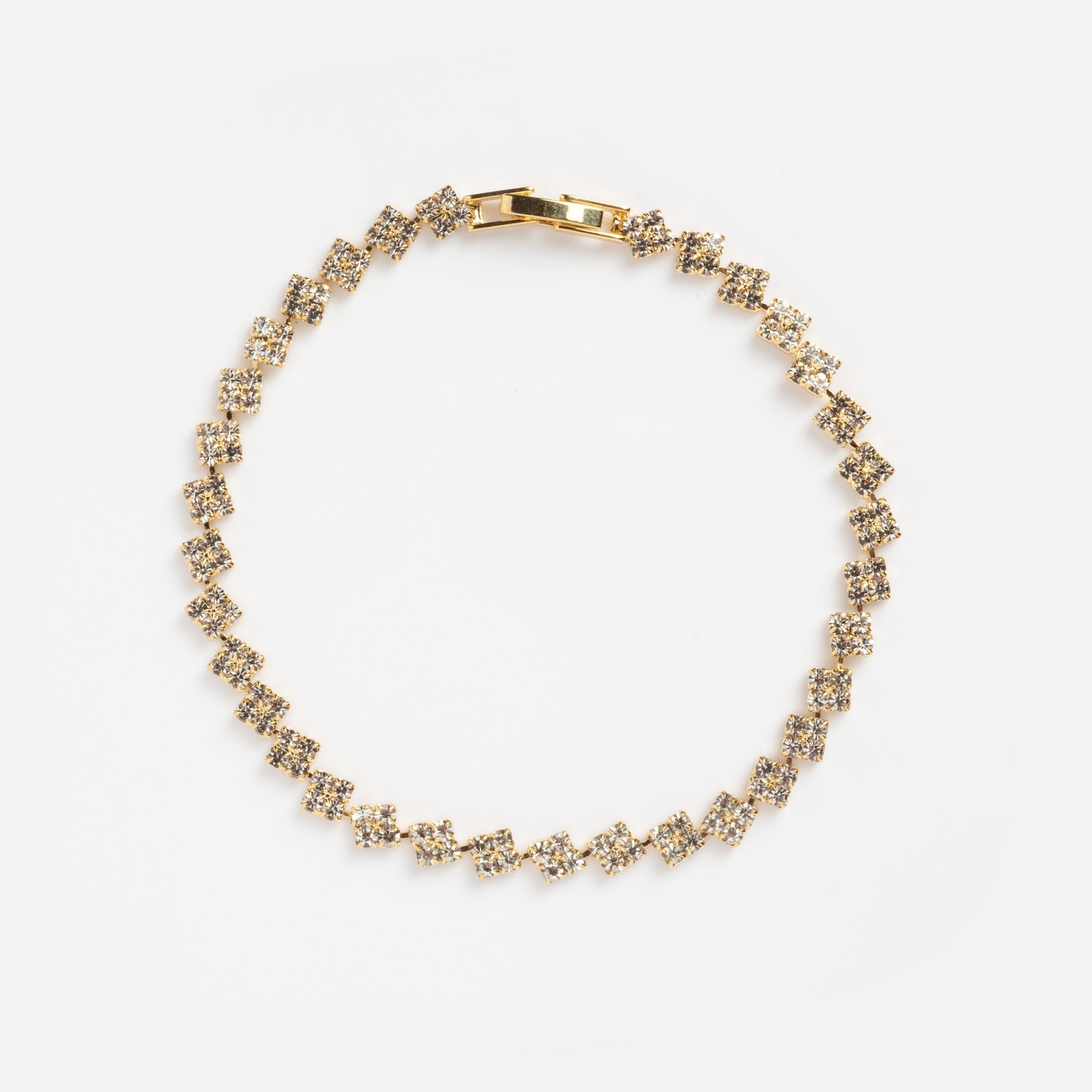 The CZ Cluter Tennis Bracelet Sample features a repeating pattern of diamond-shaped links encrusted with small clear gemstones, arranged in a circular shape against a plain white background.