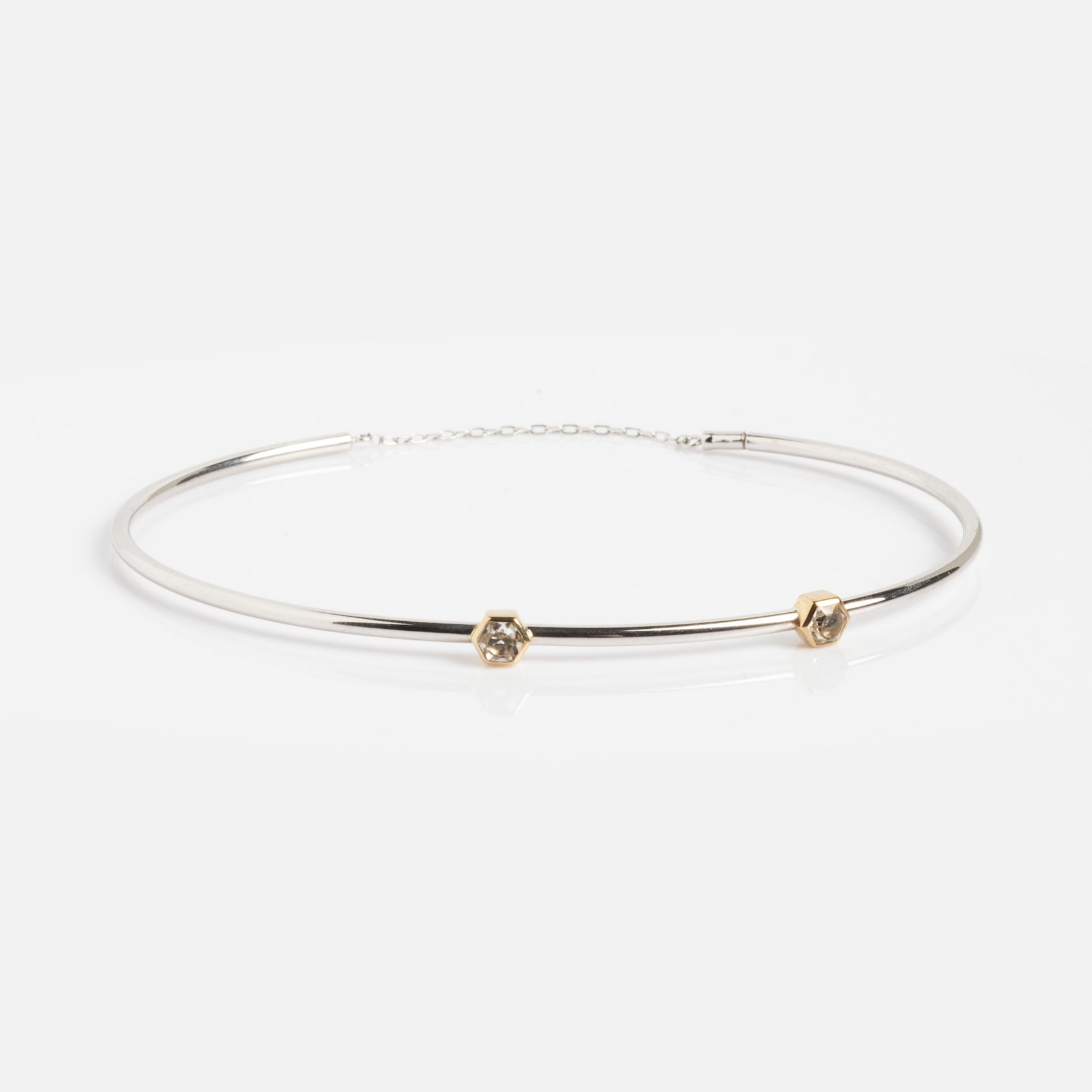 A minimalist Solid Gold White Gold Bracelet Sample, featuring a sleek design and displayed on a white background.