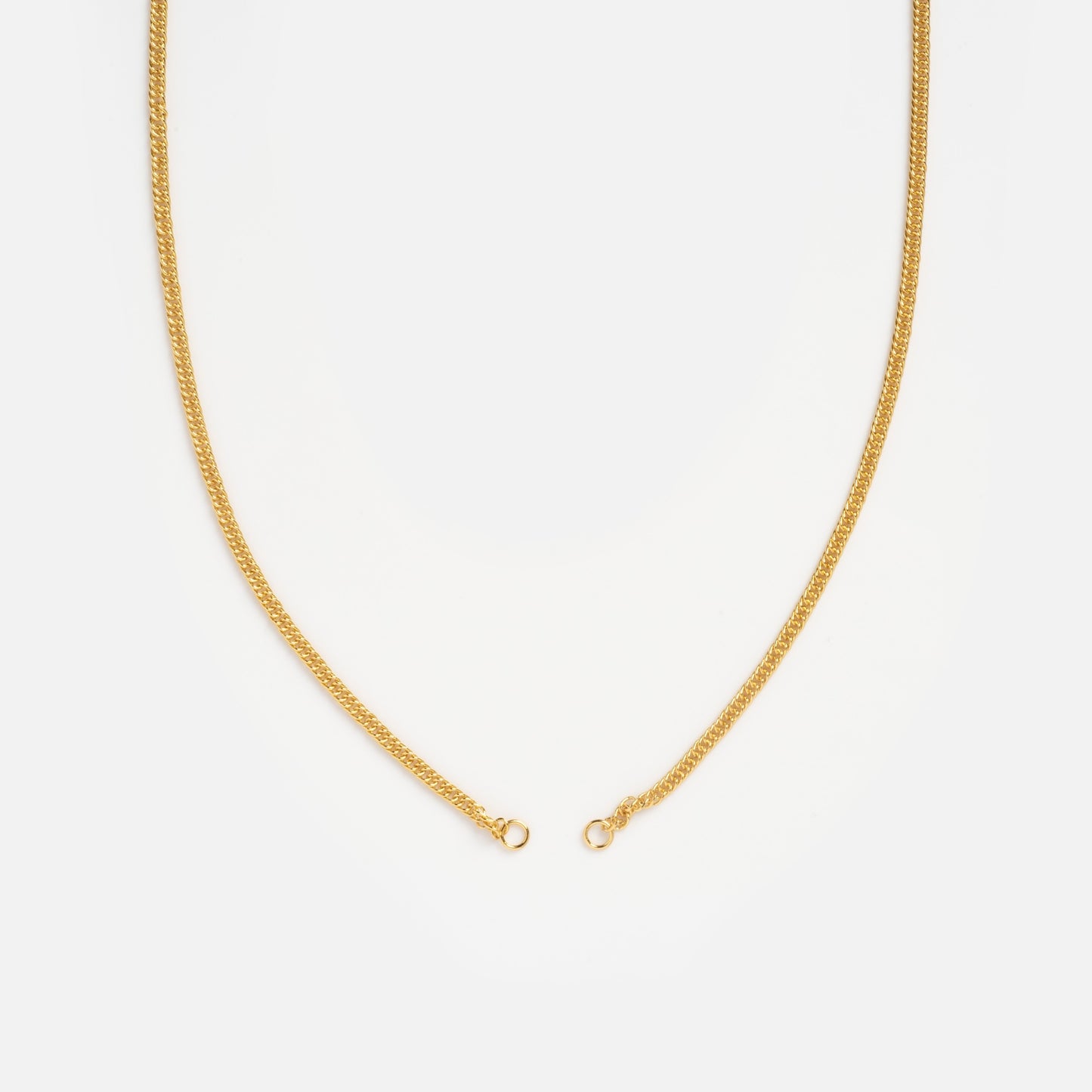 The Perfect Start Charm Holder Necklace, a thin gold plated chain with a simple clasp, lies open against a white background—ideal for displaying your favorite charms or charm clips.