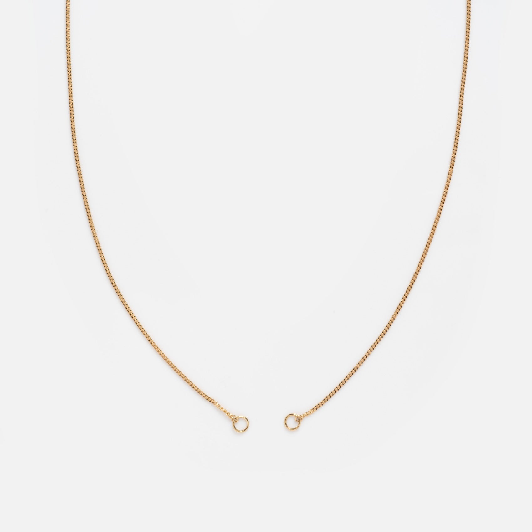 The Solid Gold Perfect Start Charm Holder Necklace in 9k gold features a unique hole design, making it ideal as a customizable charm necklace or a solid gold holder for your favorite pendants.