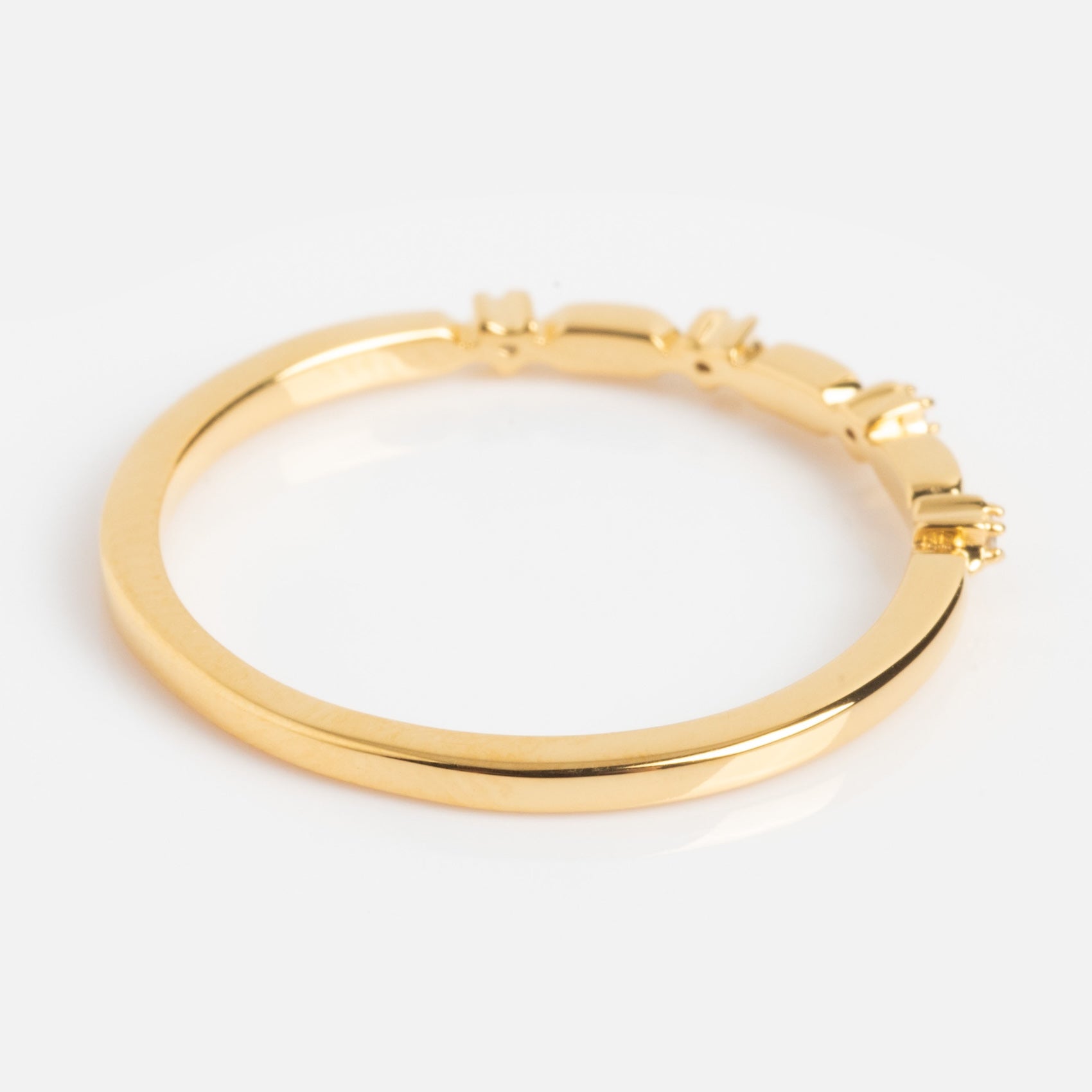 The Starry Stacking Band is a thin gold ring featuring a smooth band with subtle decorative accents on one side, shown against a white background.