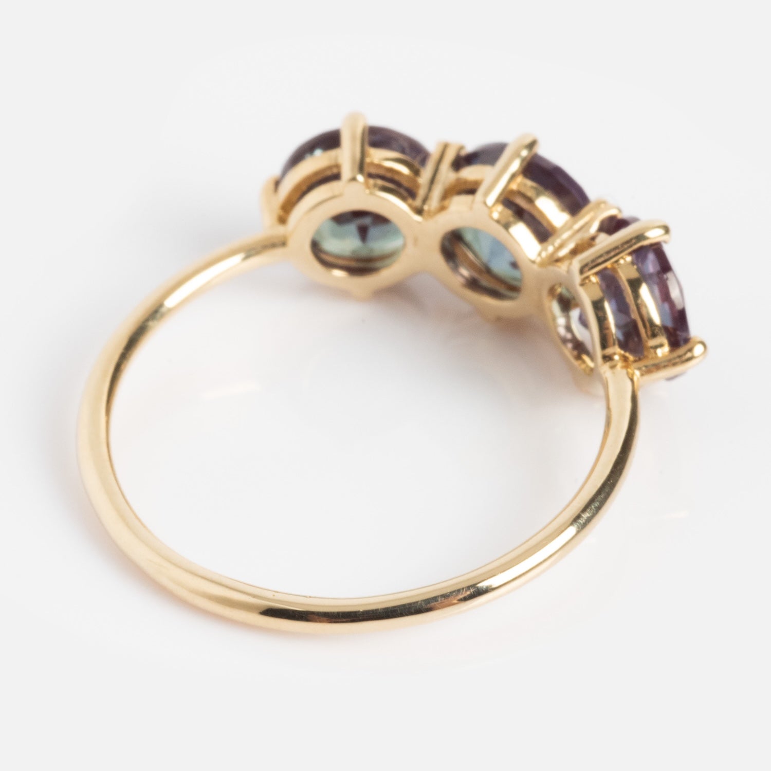 The One of a Kind 14k Heart Prong Lab Alexandrite Trio Ring showcases three large purple lab alexandrite gemstones prong-set above the band, viewed beautifully from the side.