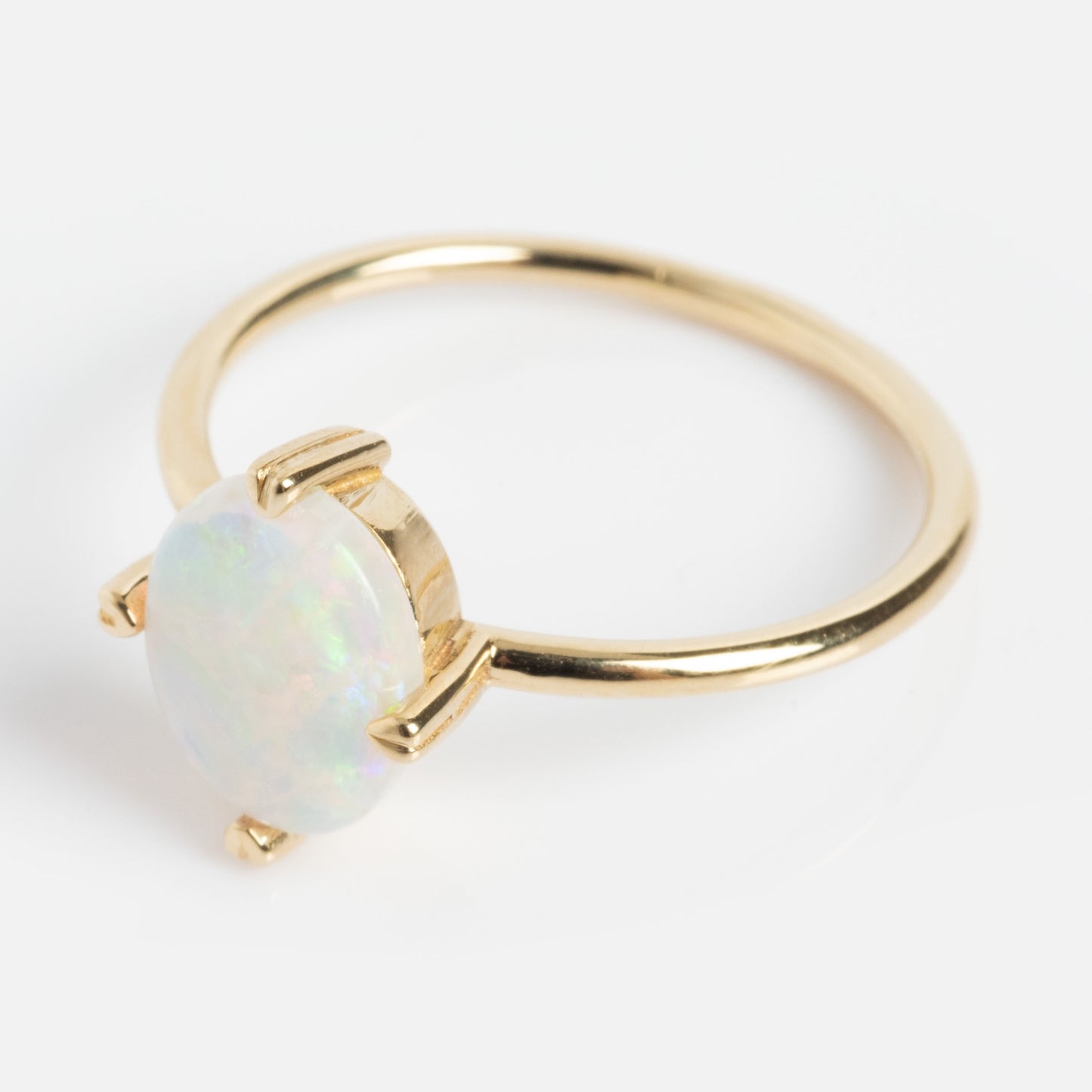 The One of a Kind 14k Heart Prong Opal Ring features a vibrant opal gemstone set in unique heart-shaped prongs, shown against a white background.