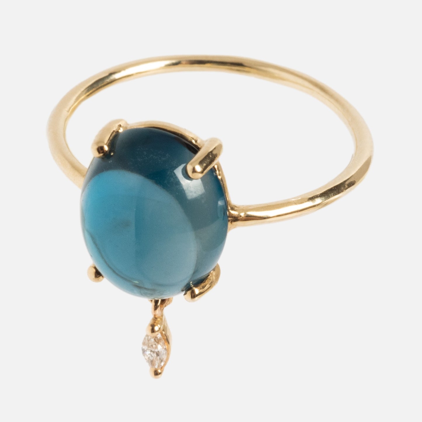 The One of a Kind 14k London Blue Topaz with Diamond Dangle Ring showcases a round blue topaz in a four-prong gold setting, accented by a dangling marquise-cut diamond beneath the main stone.